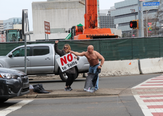 Shirtless protestor against tolls
